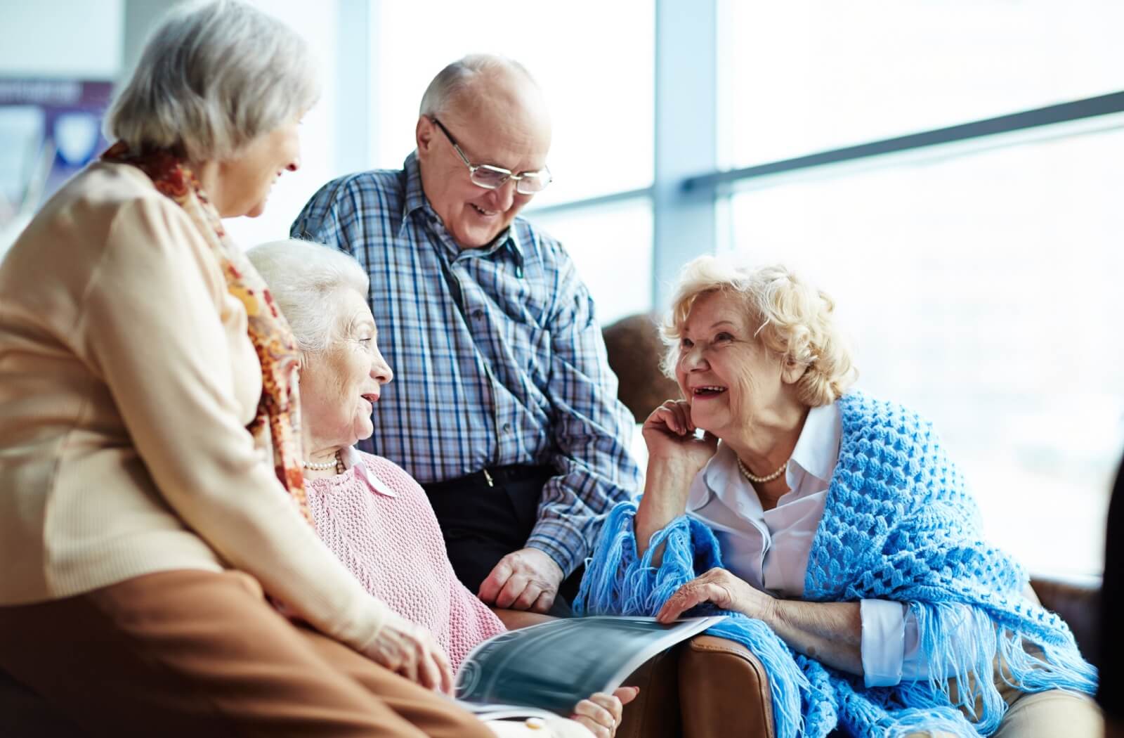 A group of happy older adults at a personal care home.